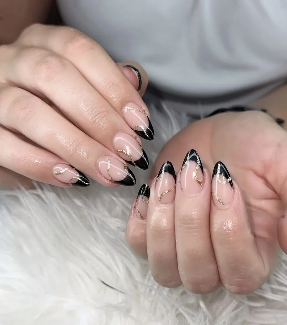Almond nails with a fine black V-shaped French tip