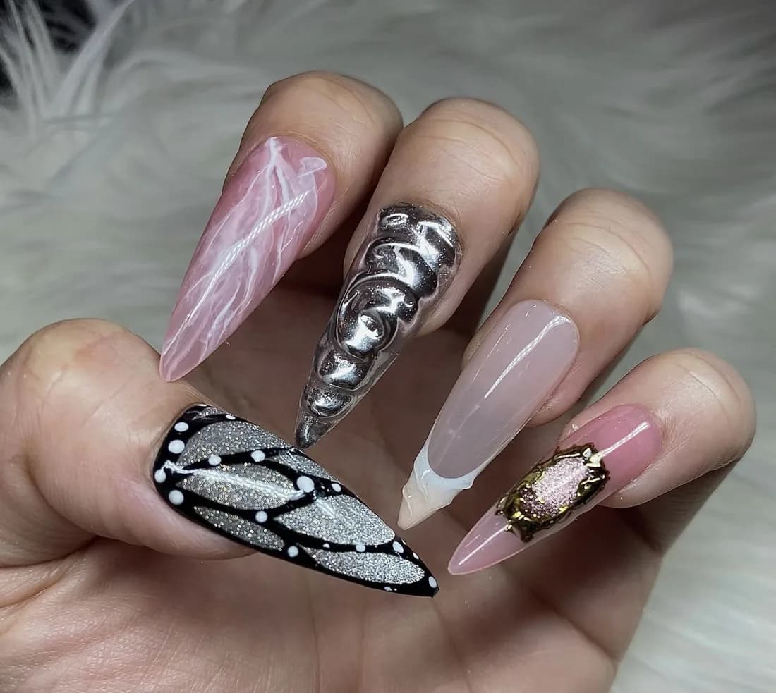 Almond nails with butterfly wing art and a silver chrome accent nail