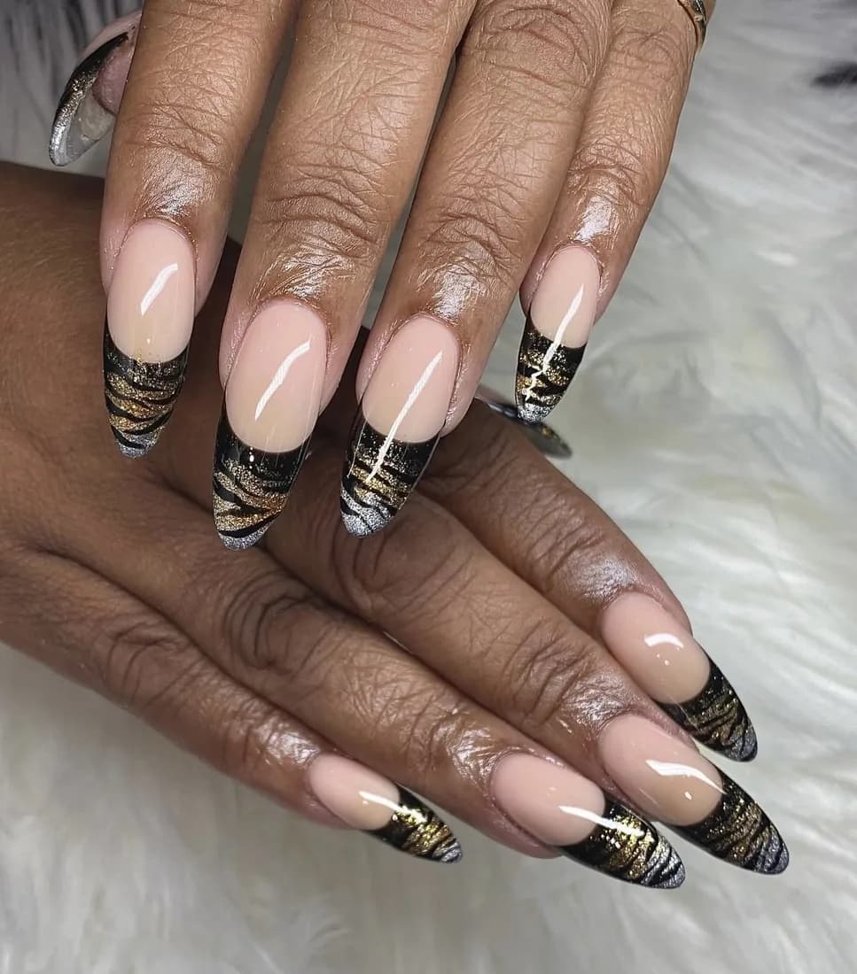 Nude nails with fine gold and black animal stripe detailing